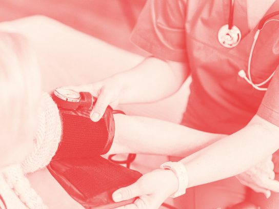 A nurse takes the blood pressure of a patient.