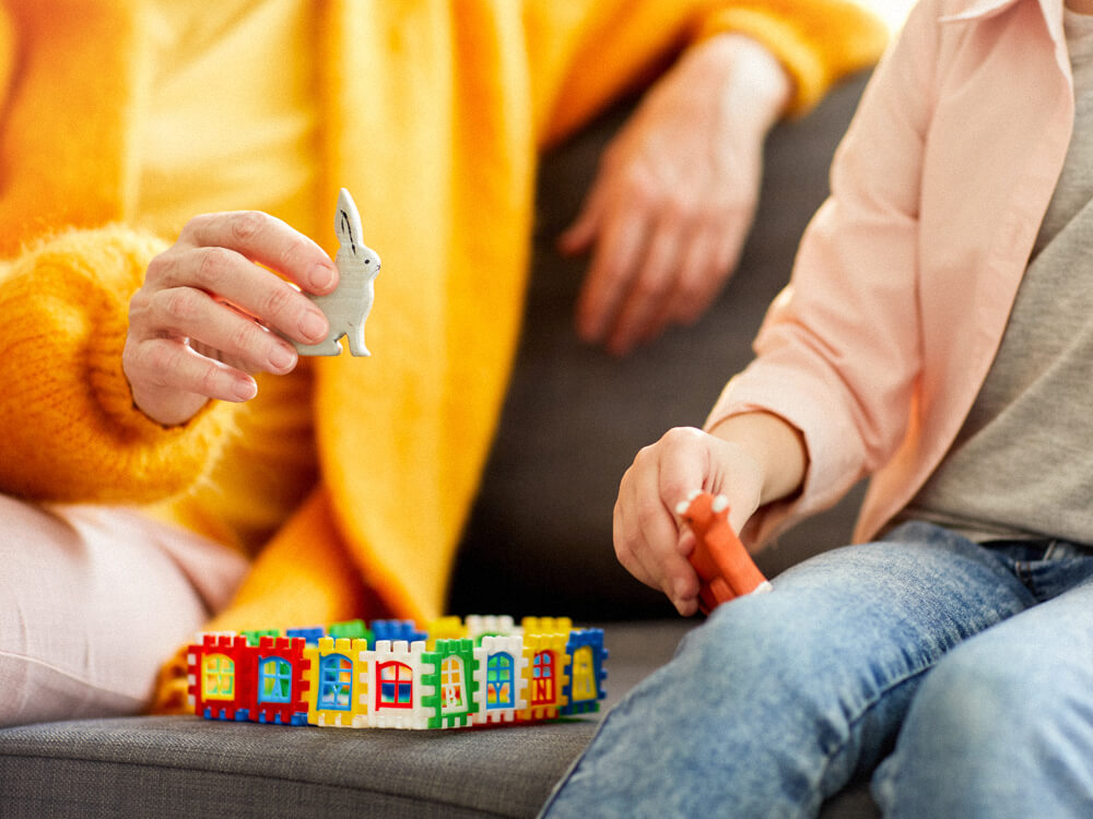 A psychiatric mental health nurse works with a child using play methods.