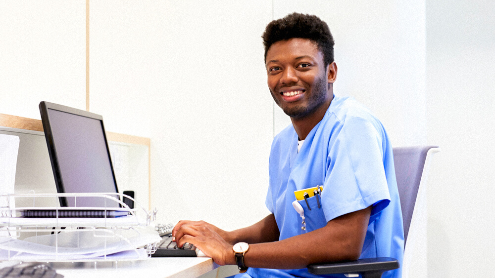 A case manager works from a desk with a computer.