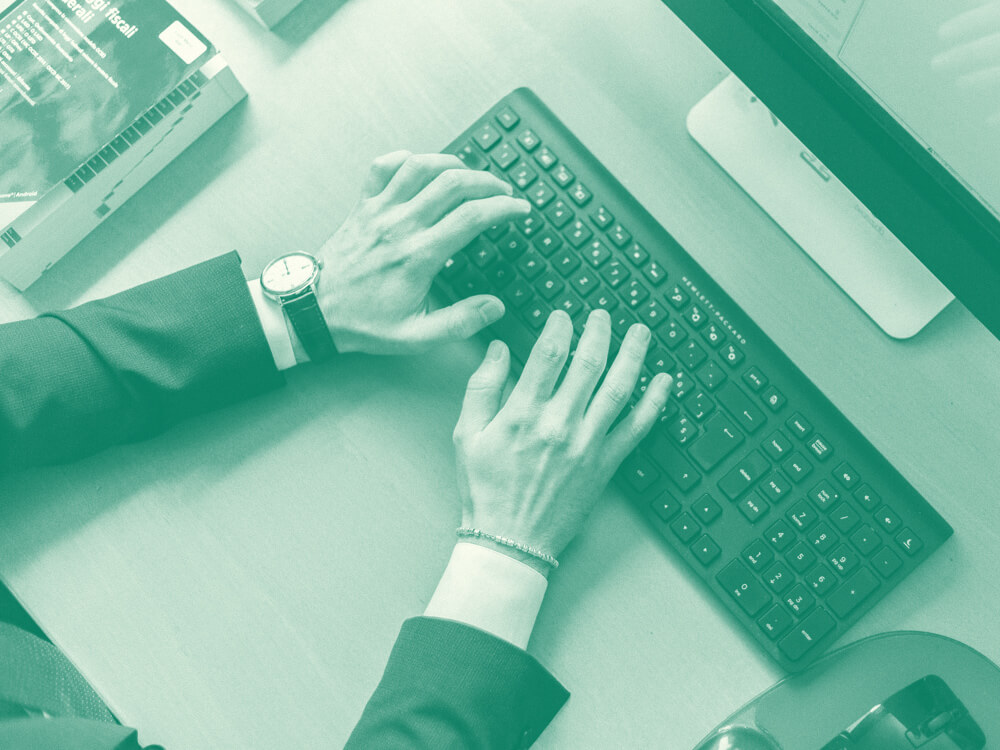 A financial planner types on a computer keyboard.