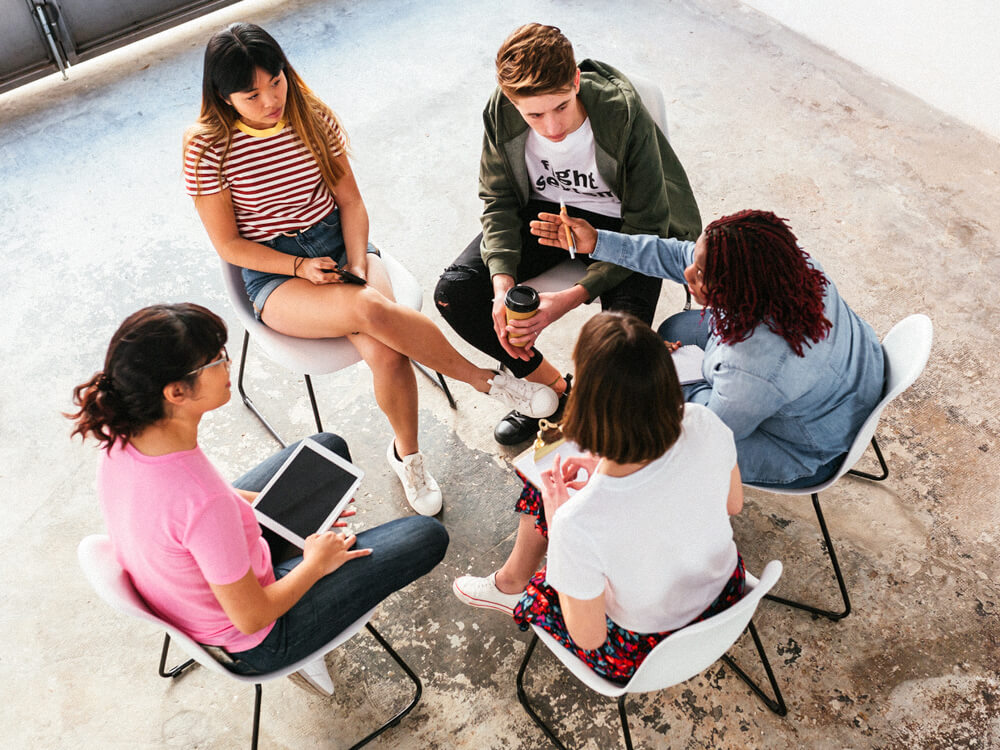 Alcohol and drug counselor works with a group of young adults.