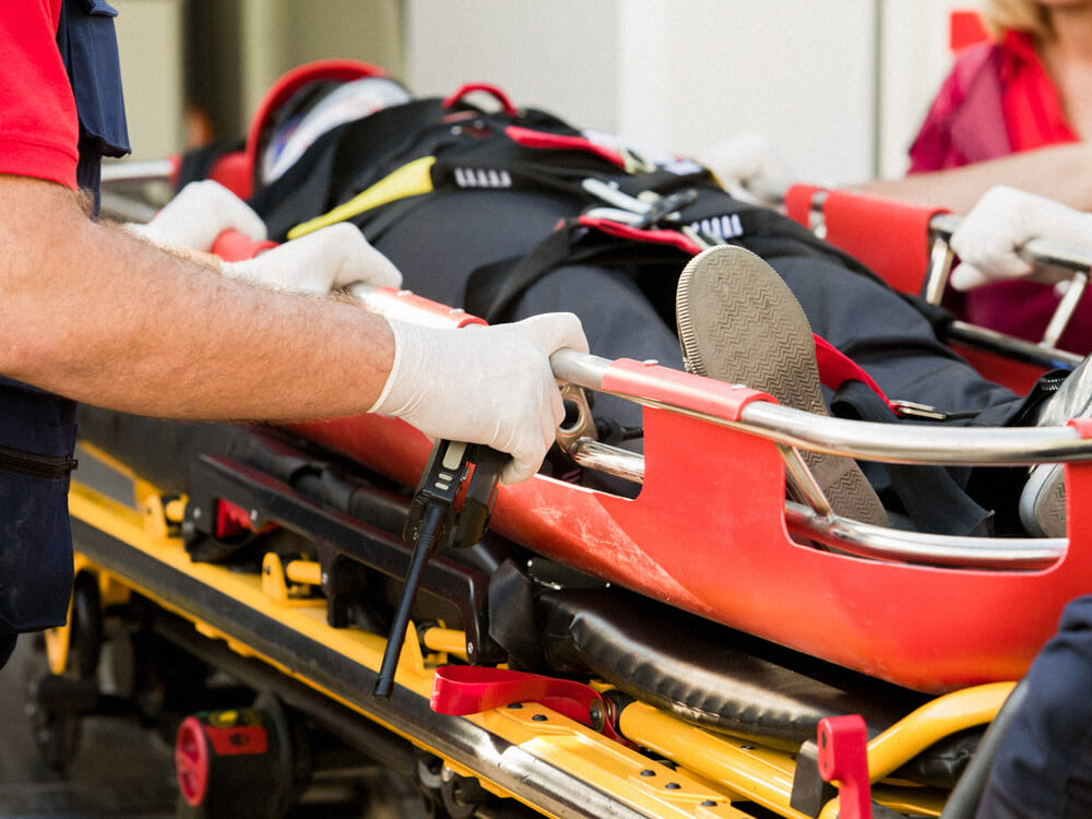 Paramedics transporting a patient on a stretcher. Close-up.