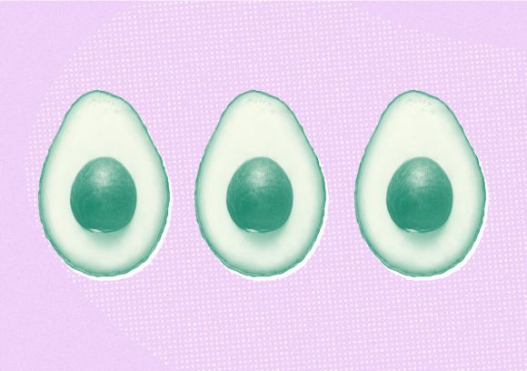 Row of three avocados cut in half on a pink background.