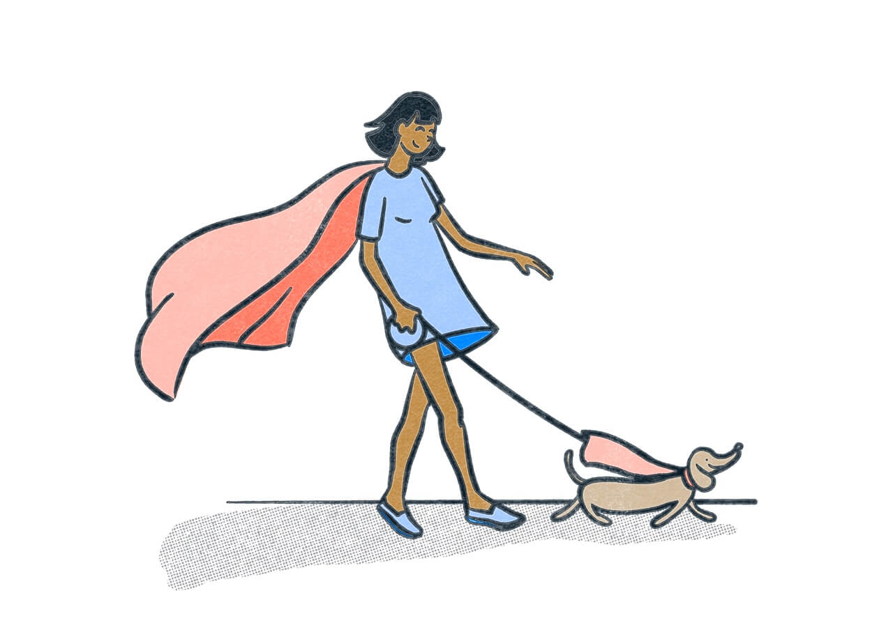 A person in a blue dress wearing a cape walking a small dog, also wearing a cape.