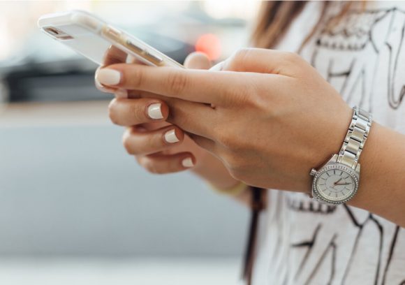 Social worker looking at different apps on their phone. Close-up.