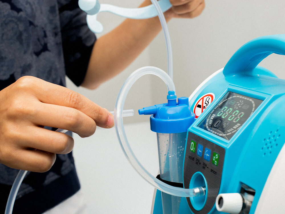 Respiratory therapist hooking up tubes to an oxygen machine. Close up.