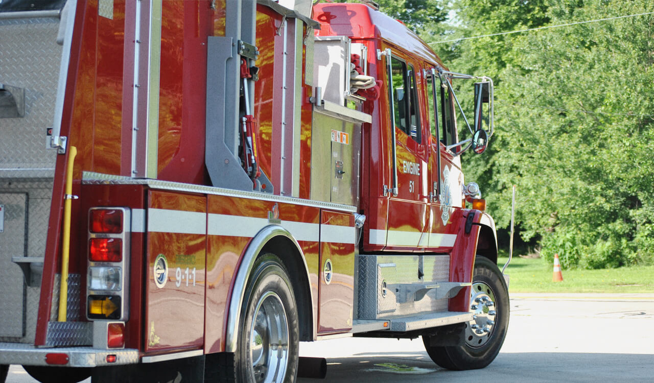 Side view of a red fire truck.