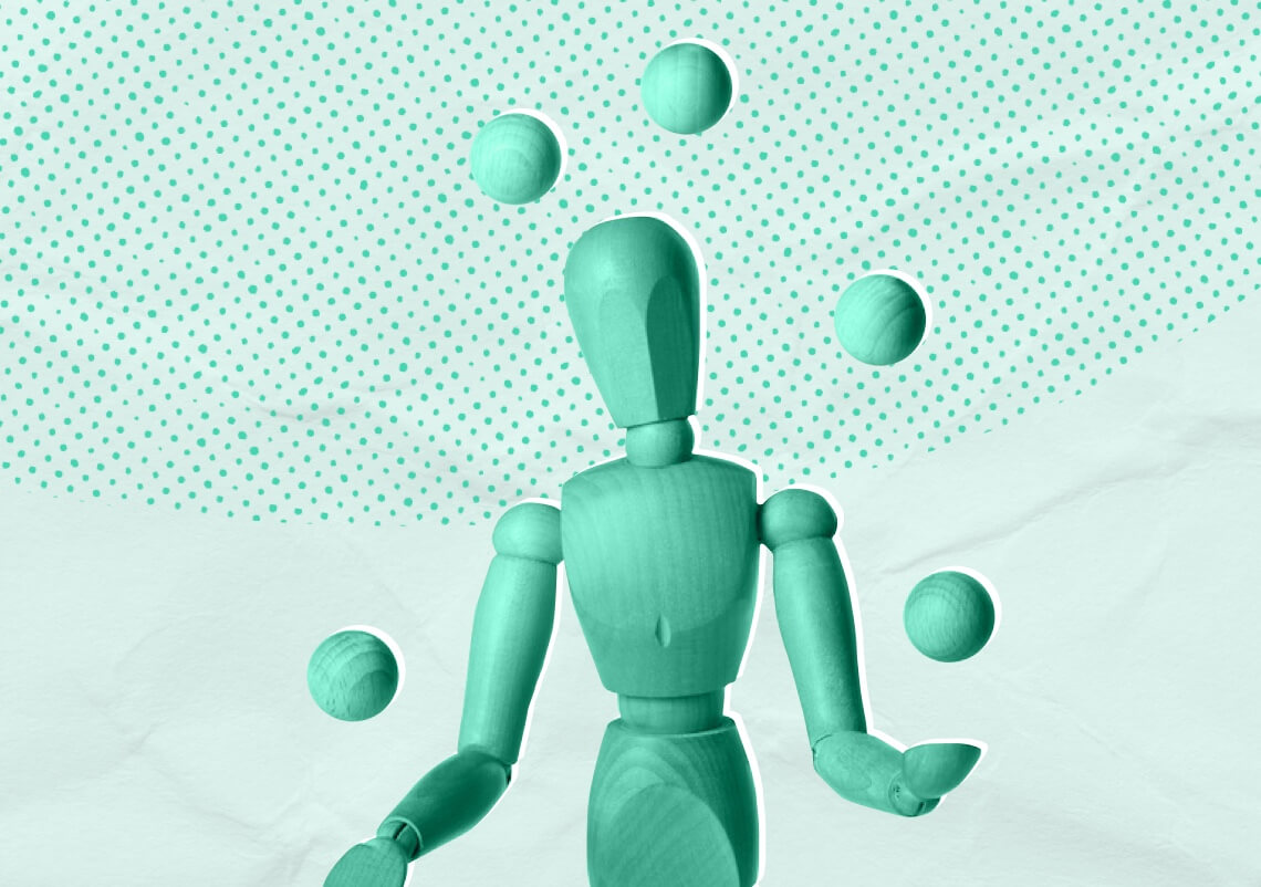 A wooden mannequin tined green juggling wooden balls against a green background.