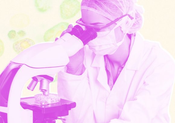 A scientist looks into a microscope. Tinted pink photograph over tinted green cell background.