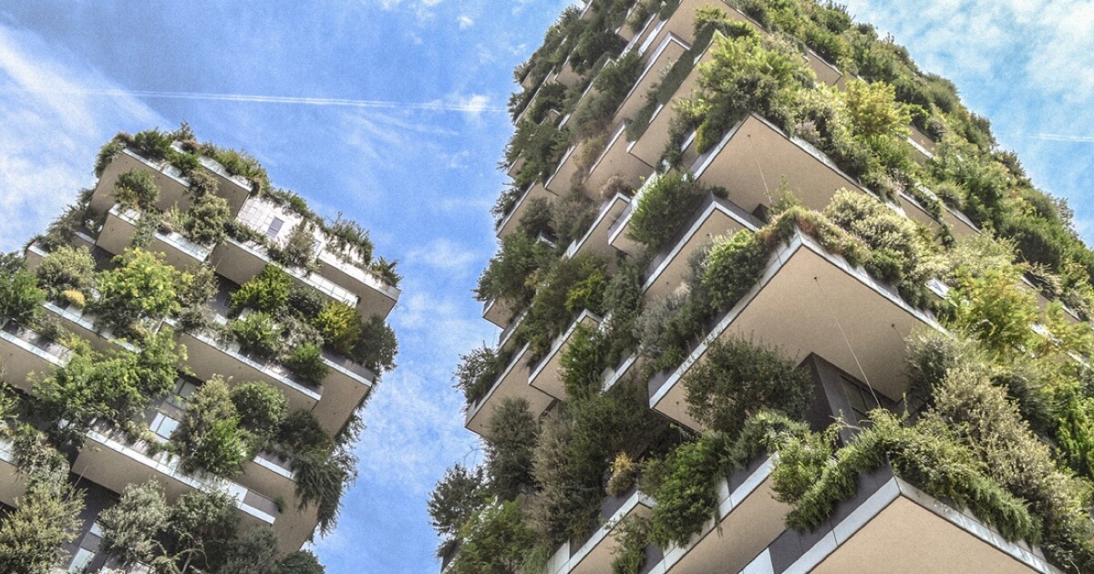 Two LEED-certified buildings with lots of greenery growing from many balconies.