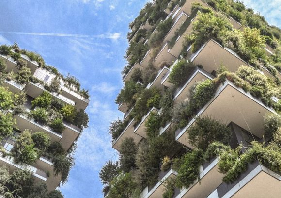 Two LEED-certified buildings with lots of greenery growing from many balconies.
