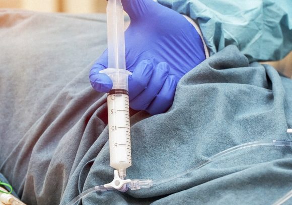 Close up of anesthesia being injected into an IV line.