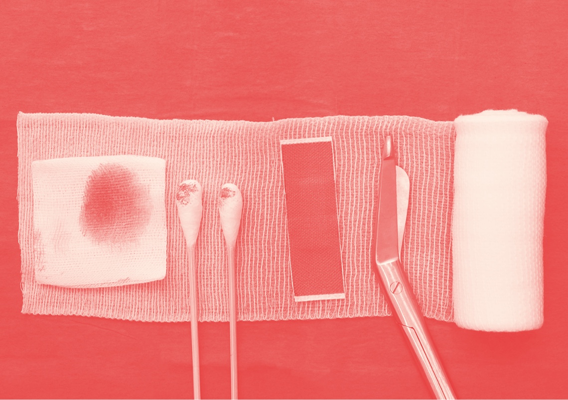 Top-down view of nursing related items including gauze, swabs and bandages. Red color overlay.